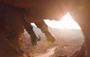 Preview wallpaper feet, cave, rock, mountain, sunset