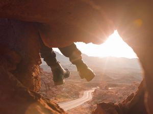 Preview wallpaper feet, cave, rock, mountain, sunset