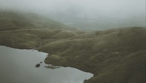 Preview wallpaper feet, lake, fog, hills, slope