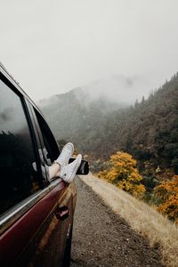 Preview wallpaper feet, sneakers, journey, fog, car