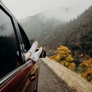 Preview wallpaper feet, sneakers, journey, fog, car