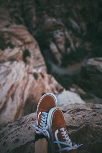 Preview wallpaper feet, sneakers, red, stones, rocks