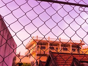 Preview wallpaper fence, mesh, building, sky, pink