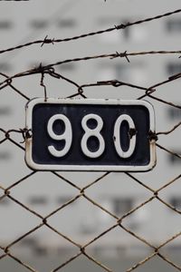 Preview wallpaper fence, mesh, numerals, barbed wire