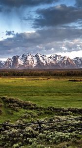 Preview wallpaper fence, mountains, field, pasture, clouds