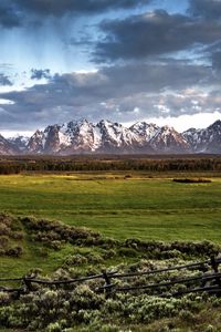 Preview wallpaper fence, mountains, field, pasture, clouds