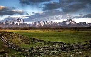 Preview wallpaper fence, mountains, field, pasture, clouds