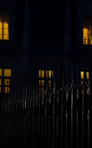 Preview wallpaper fence, spikes, building, windows, night, dark