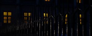 Preview wallpaper fence, spikes, building, windows, night, dark