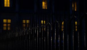 Preview wallpaper fence, spikes, building, windows, night, dark