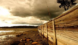 Preview wallpaper fence, stones, sea, coast, fishing tackles