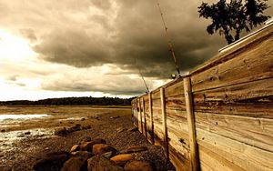 Preview wallpaper fence, stones, sea, coast, fishing tackles