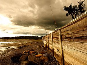 Preview wallpaper fence, stones, sea, coast, fishing tackles