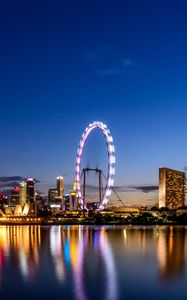 Preview wallpaper ferris wheel, night city, skyscrapers, ocean, beach