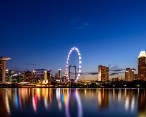 Preview wallpaper ferris wheel, night city, skyscrapers, ocean, beach