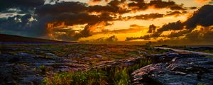 Preview wallpaper field, plain, grass, stones, sunset, dark