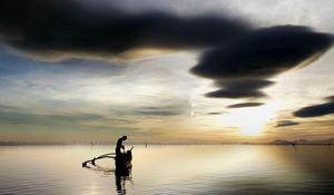 Preview wallpaper fisherman, lake, clouds, sky, boat