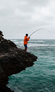Preview wallpaper fishing, fisherman, boy, fishing rod, rock, sea