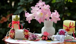 Preview wallpaper flowers, vase, roses, bags, bows, candles, table