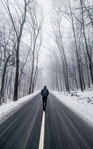 Preview wallpaper fog, man, snow, trees, road, loneliness