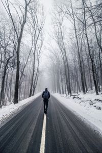 Preview wallpaper fog, man, snow, trees, road, loneliness