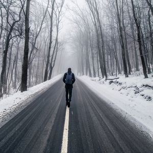 Preview wallpaper fog, man, snow, trees, road, loneliness