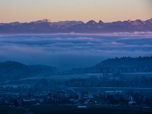 Preview wallpaper fog, mountains, twilight, winter, sky, switzerland