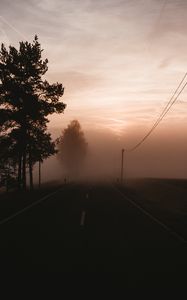 Preview wallpaper fog, road, trees, twilight, sky