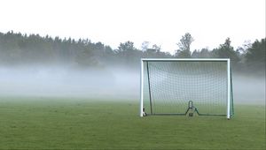 Preview wallpaper football goal, field, football, fog, trees, haze