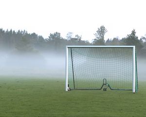 Preview wallpaper football goal, field, football, fog, trees, haze