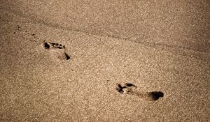 Preview wallpaper footprints, beach, coast, sand, sea