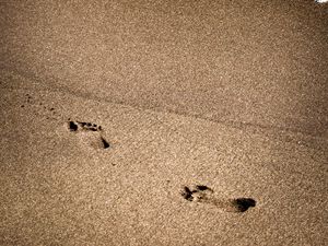 Preview wallpaper footprints, beach, coast, sand, sea
