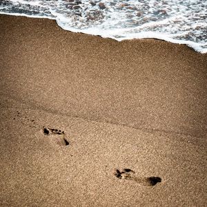 Preview wallpaper footprints, beach, coast, sand, sea