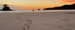 Preview wallpaper footprints, sand, beach, sea, silhouette, sunset