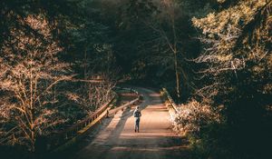 Preview wallpaper forest, road, man, lonely, loneliness, trees, branches