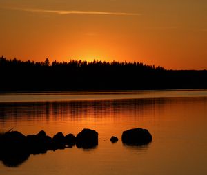 Preview wallpaper forest, silhouettes, lake, stones, twilight, dark, orange