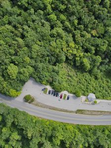 Preview wallpaper forest, trees, road, parking, cars, aerial view