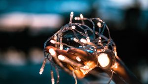 Preview wallpaper garland, hands, light, blur, light bulbs