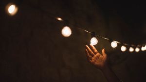 Preview wallpaper garland, light bulbs, hand, touch, light