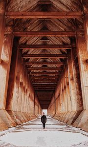 Preview wallpaper girl, alone, building, tunnel, columns, snow, winter