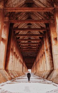 Preview wallpaper girl, alone, building, tunnel, columns, snow, winter