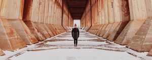 Preview wallpaper girl, alone, building, tunnel, columns, snow, winter