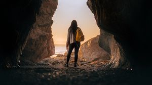 Preview wallpaper girl, alone, cave, sunset