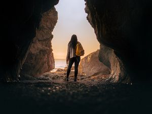 Preview wallpaper girl, alone, cave, sunset