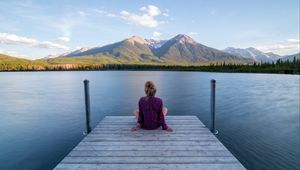 Preview wallpaper girl, alone, pier, water, mountains, view