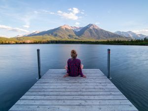 Preview wallpaper girl, alone, pier, water, mountains, view