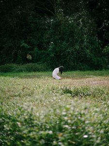 Preview wallpaper girl, alone, sad, field, trees, grass