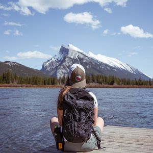 Preview wallpaper girl, backpack, pier, lake, mountain, travel