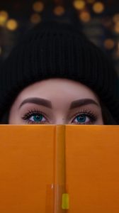 Preview wallpaper girl, book, glance, eyes, face
