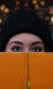 Preview wallpaper girl, book, glance, eyes, face